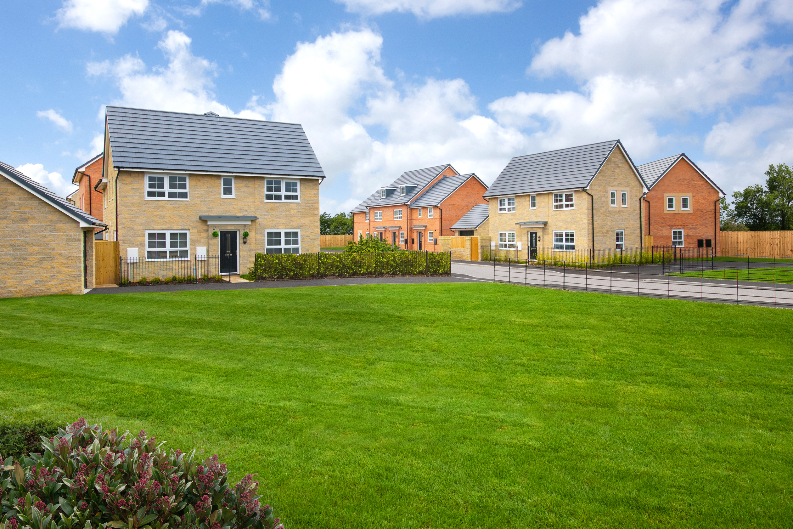 Imperial Park Two street scene showing turfed public open space to front aspect featuring Ennerdale, Folkestone and Queensville house types 