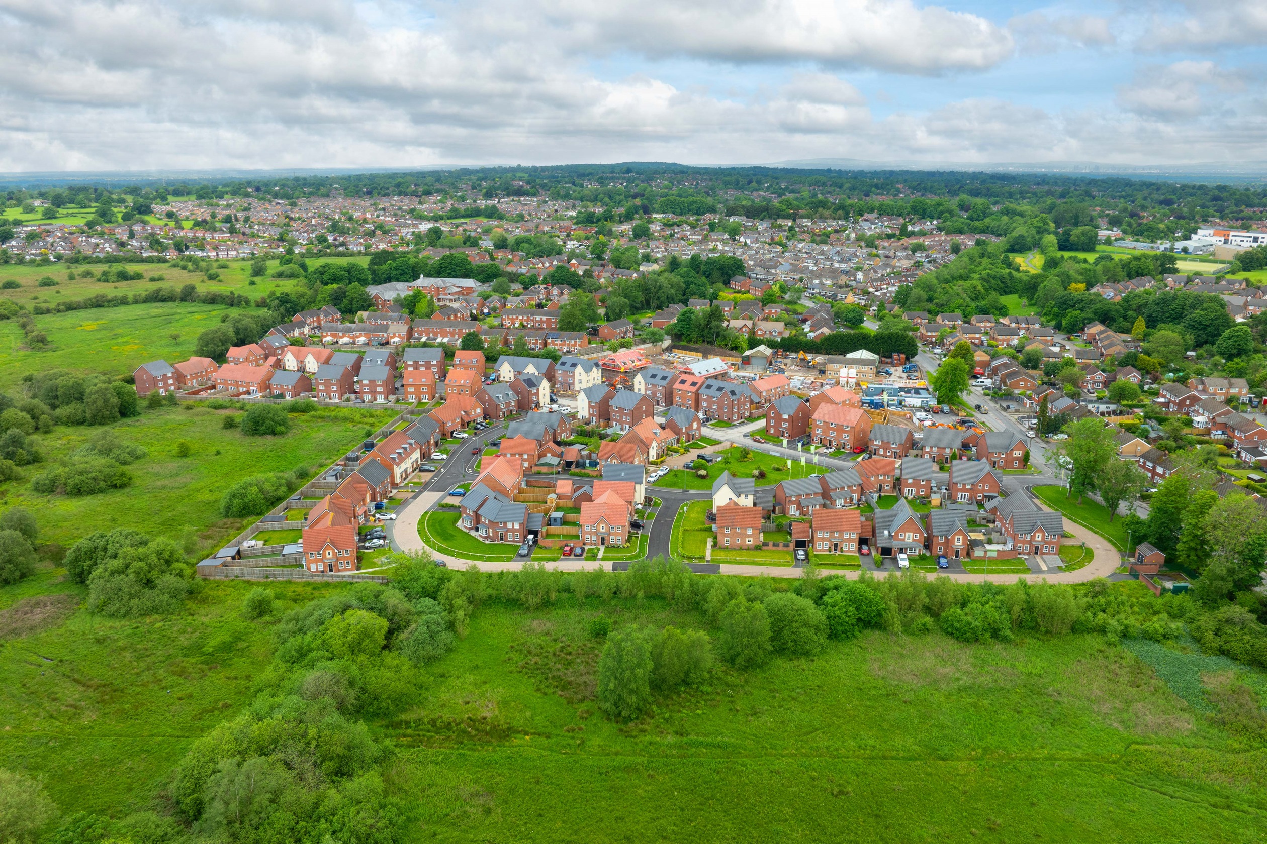 drone view overlooking Silk Waters Green development in Macclesfield 
