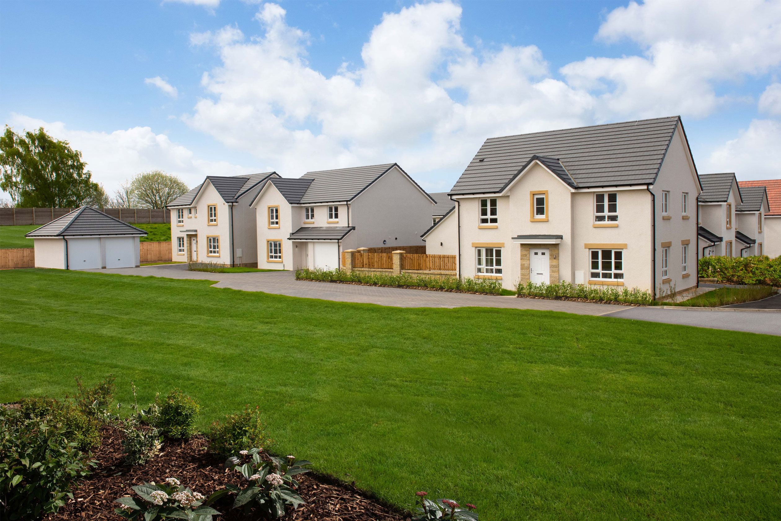 Street scene showing green space and detached homes