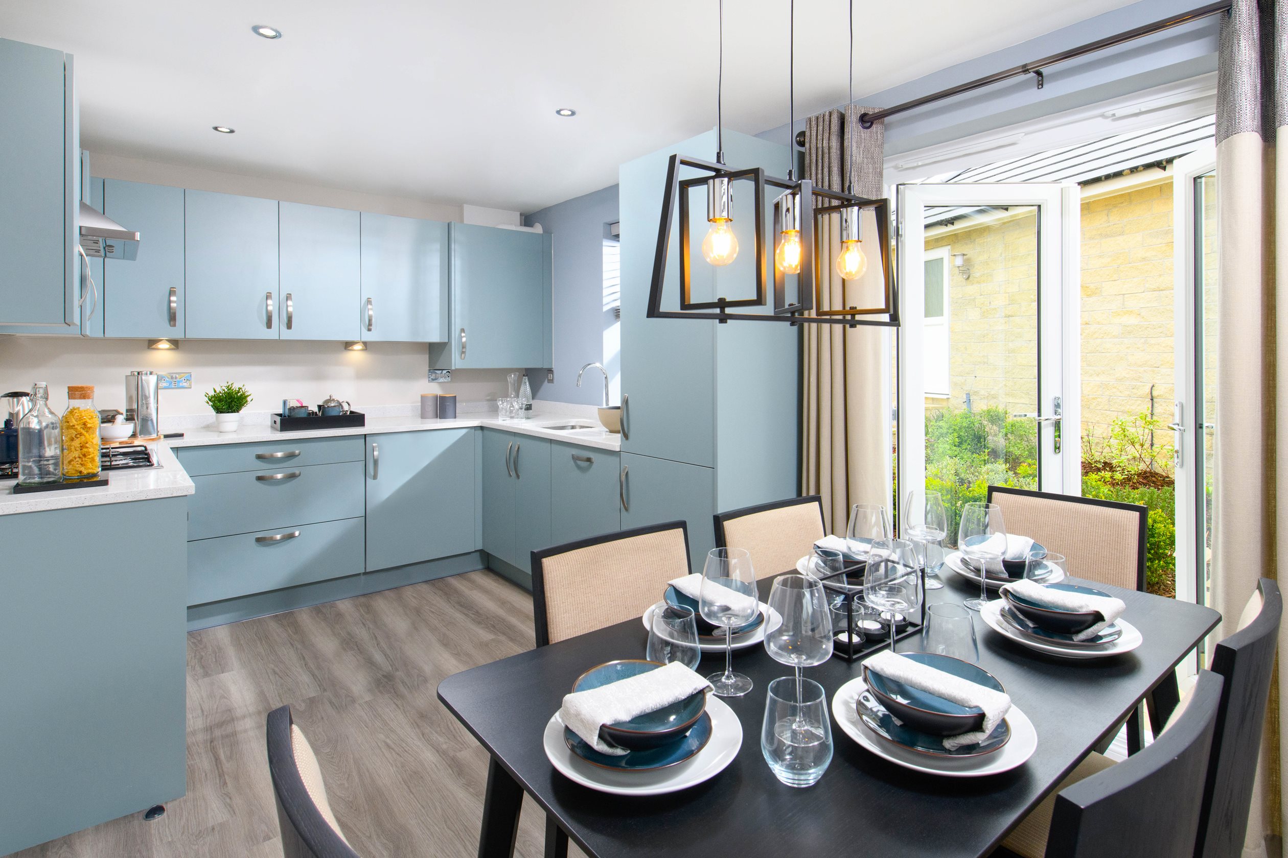 Open-plan kitchen/diner with French doors onto garden in Moresby style home