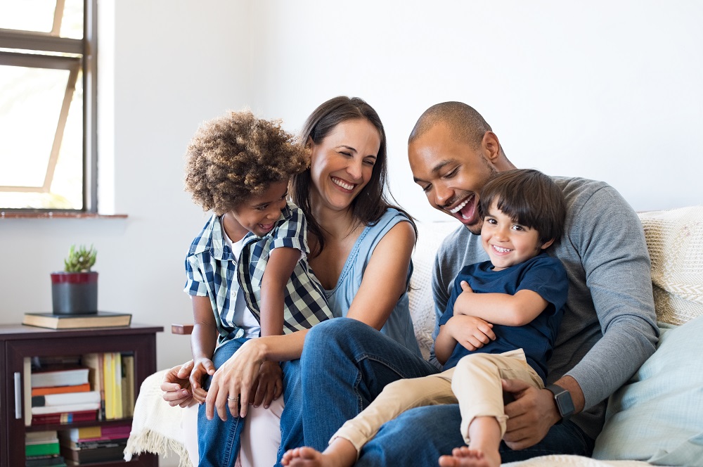 Family laughing on the sofa