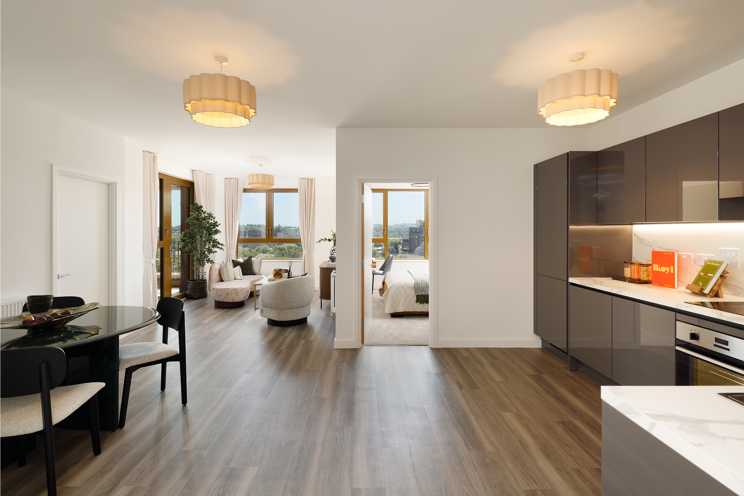 Wide-angle shot towards living area and kitchen