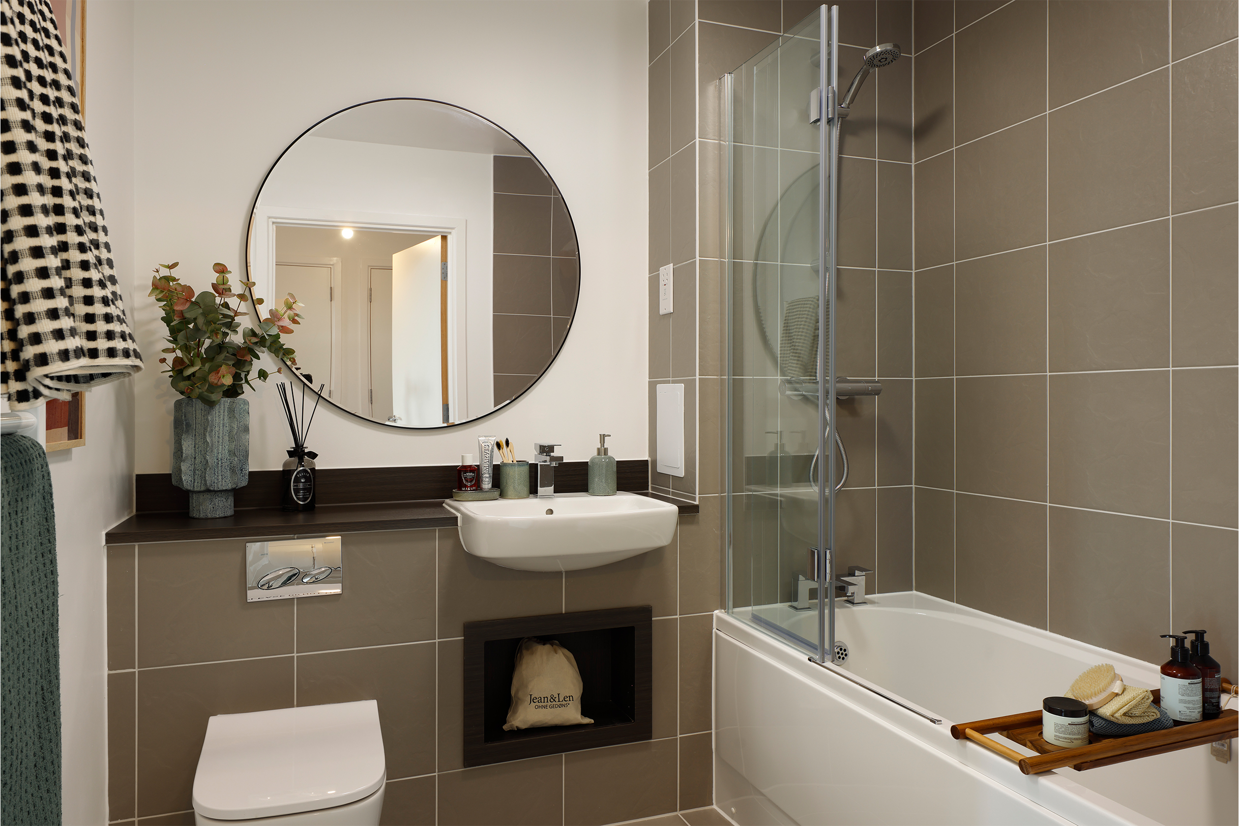 Angle towards grey tiled bathroom