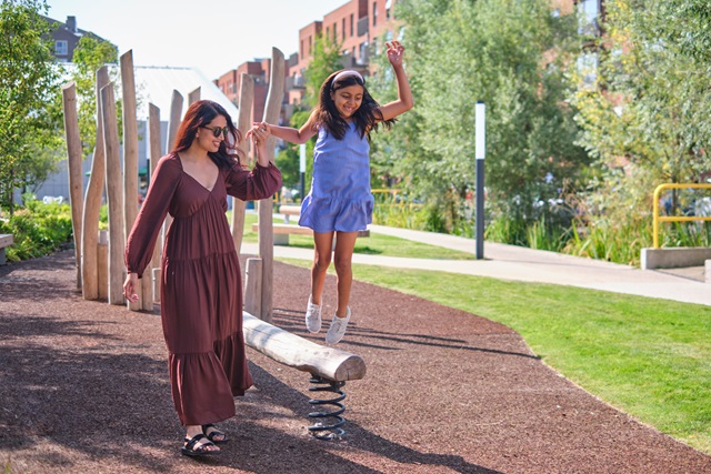 Girl and mother playing in playground outside