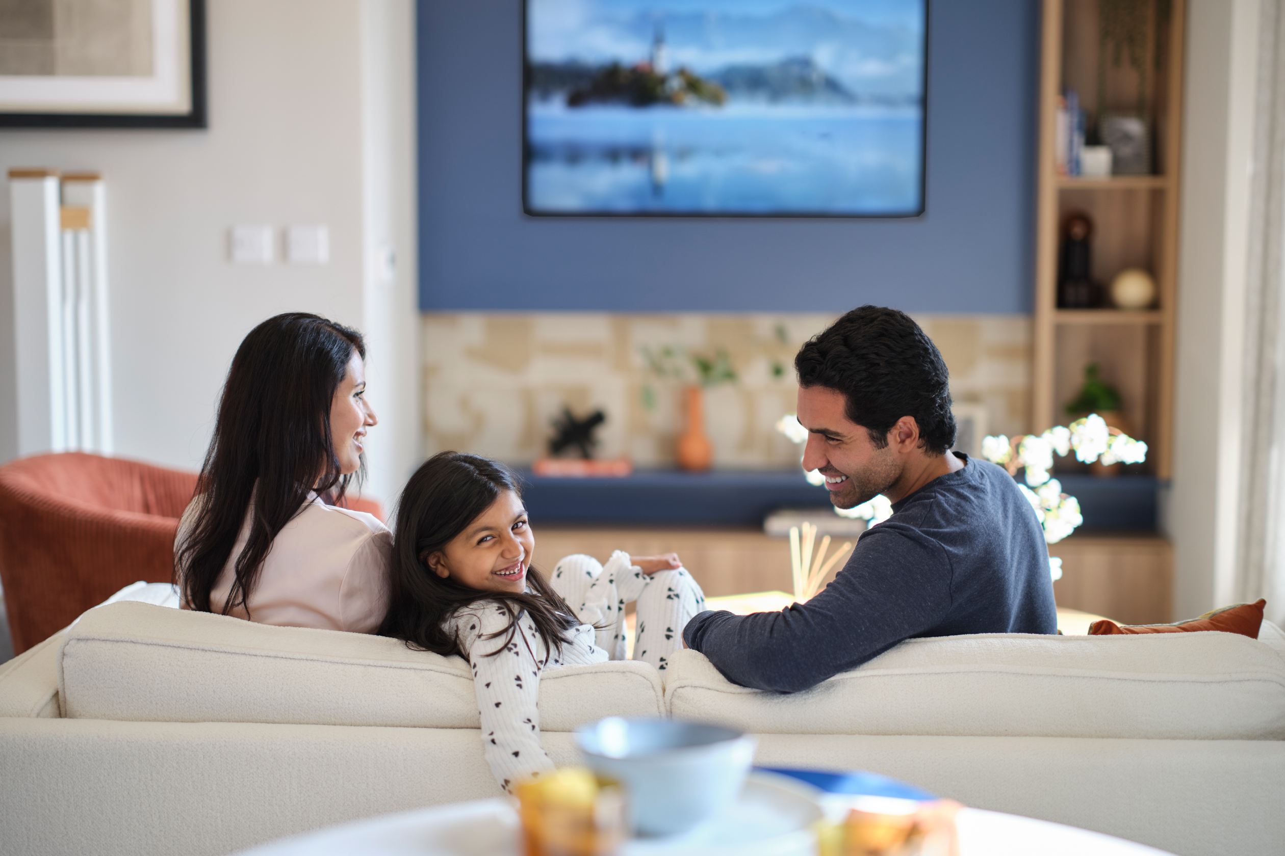 Family sitting on sofa in living room