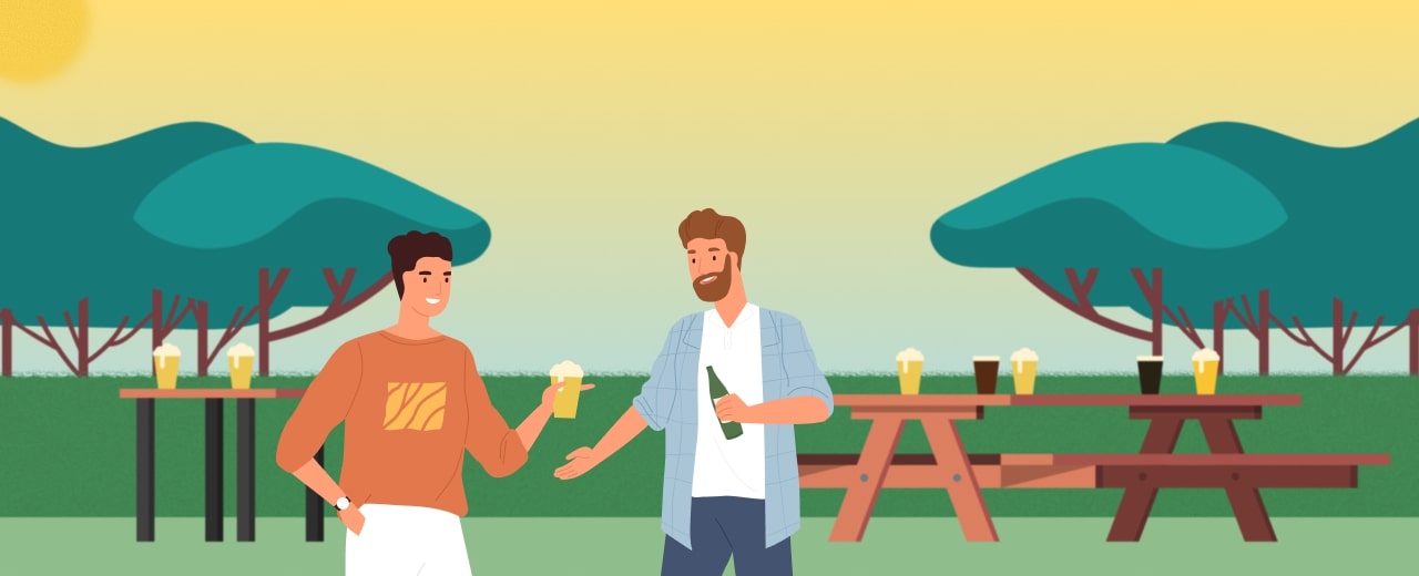Image of two men enjoying pints of beer in a park